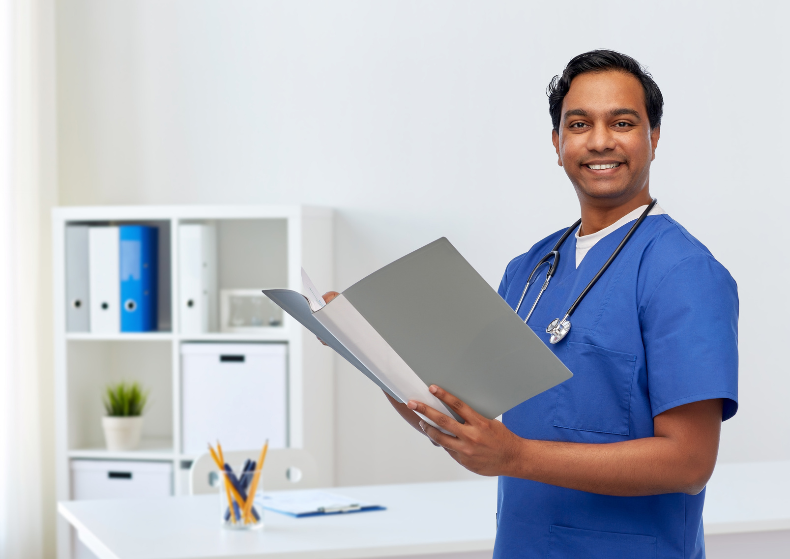 Happy Indian Doctor with Medical Report in Folder